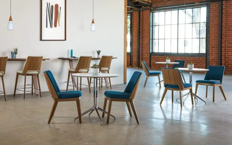 Café Dining Area Blue and brown chairs at café tables in a brick loft