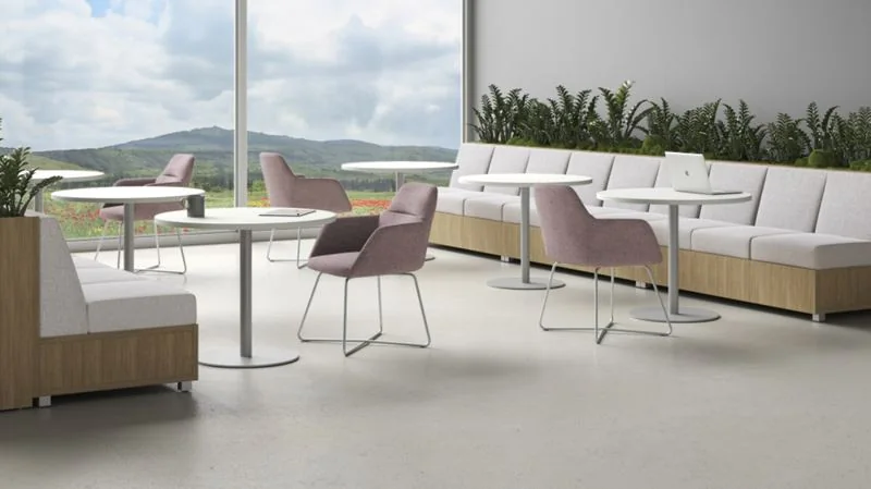Café and Lounge Café tables and chairs beside low white lounge seating