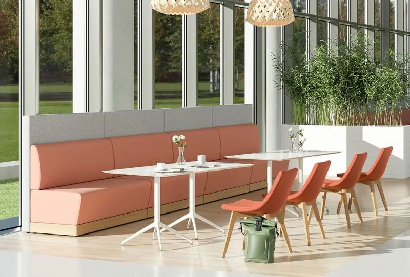Banquette Seating Coral banquette with café tables and red chairs
