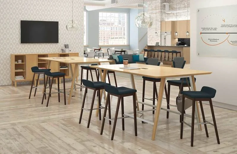 High-Top Café Seating High wood tables with dark bar stools in an office café
