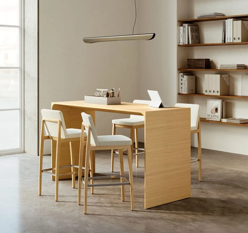 High-Top Table Light oak high-top table with stools in a library corner