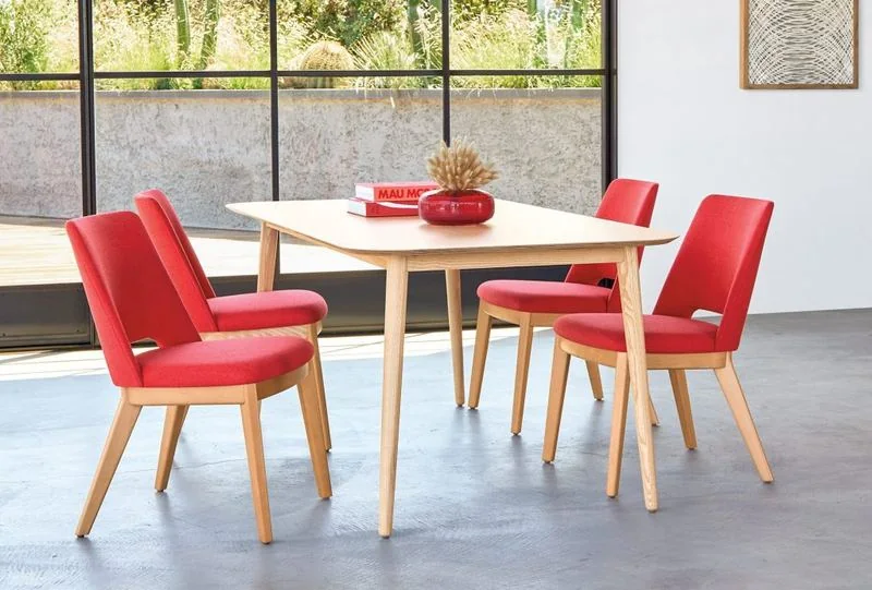 Café Table and Chairs Red upholstered chairs around a light wood table