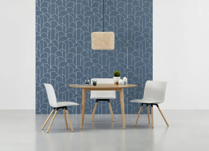Café Table and Chairs White chairs at a wood table against a blue patterned wall
