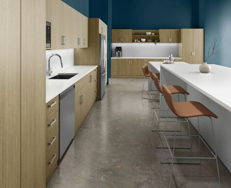 Breakroom Counter Wood breakroom cabinetry with cognac bar stools at the counter