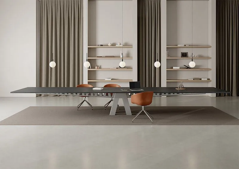 Boardroom Table Long dark boardroom table with sculpted base in a modern room
