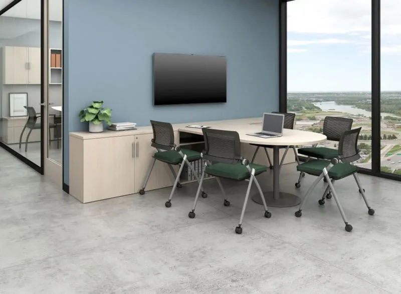 Meeting Room Small meeting room with round table and green chairs by a window