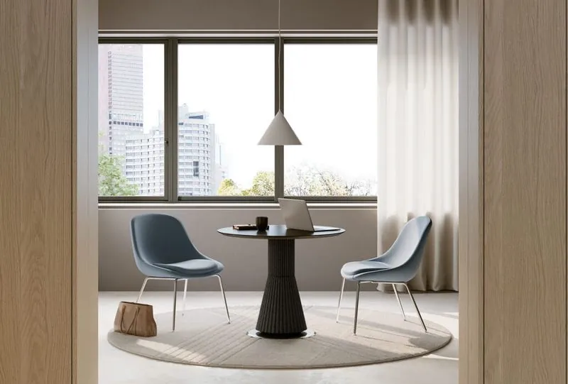 Round Meeting Table Small round meeting table with two chairs by a window