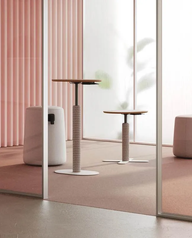 Adjustable Tables Adjustable tables in a pink room with glass partition