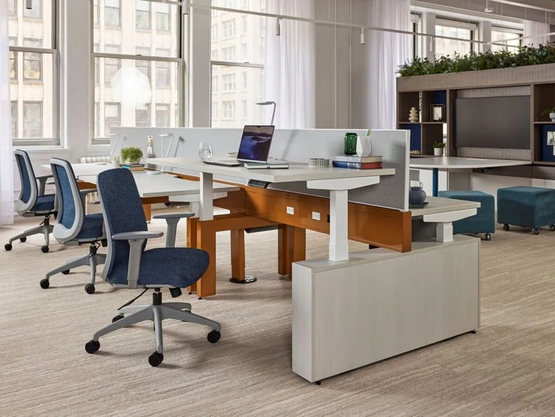 Height-Adjustable Benching Height-adjustable benching with oak accents and navy chairs