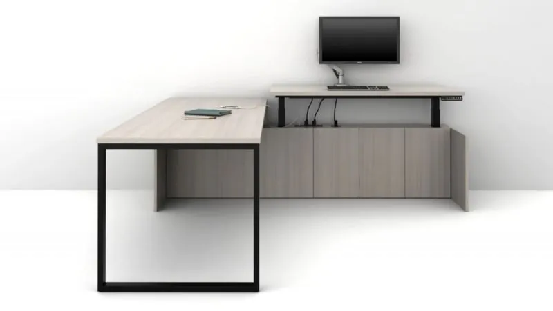 L-Shaped Standing Desk L-shaped height-adjustable desk with raised return and monitor