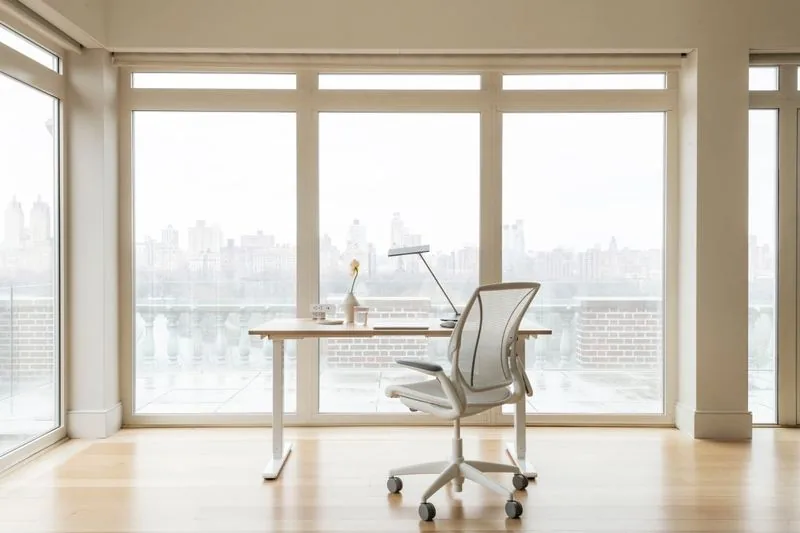 Sit-Stand Desk Sit-stand desk by a window flooded with daylight