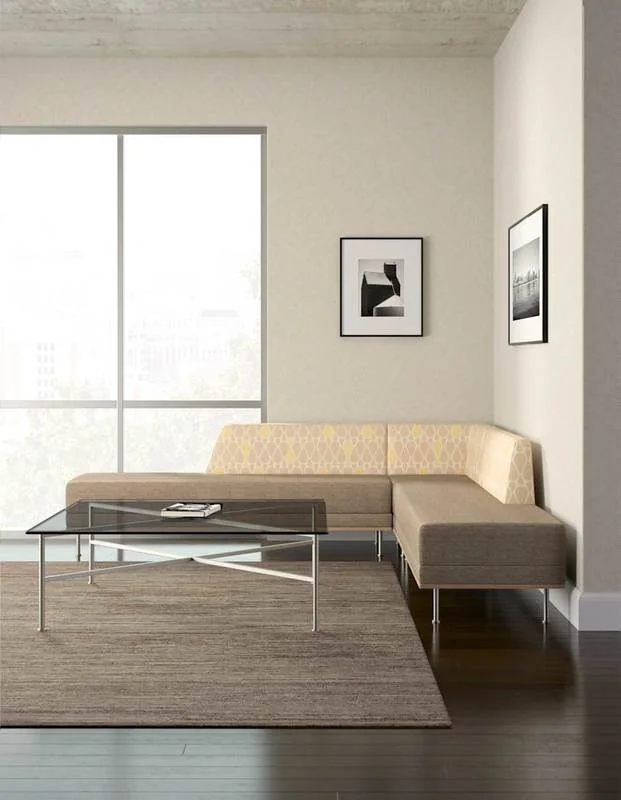 Beige sectional sofa with a glass coffee table