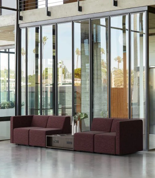 Burgundy modular seating by tall glass doors
