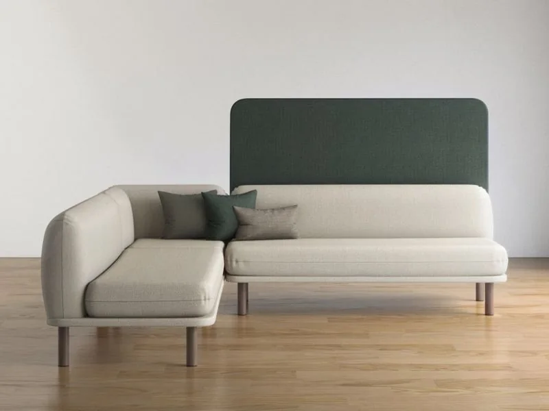 Cream sofa with a dark green high back panel