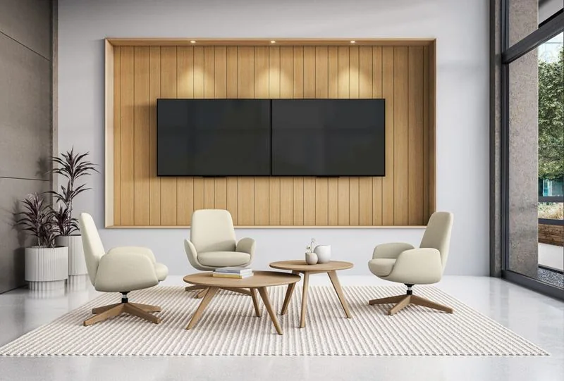 Cream swivel lounge chairs around a wood table beneath a slatted wall
