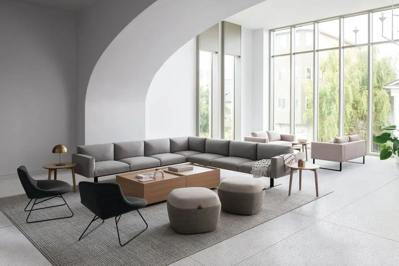 Gray sectional with black lounge chairs