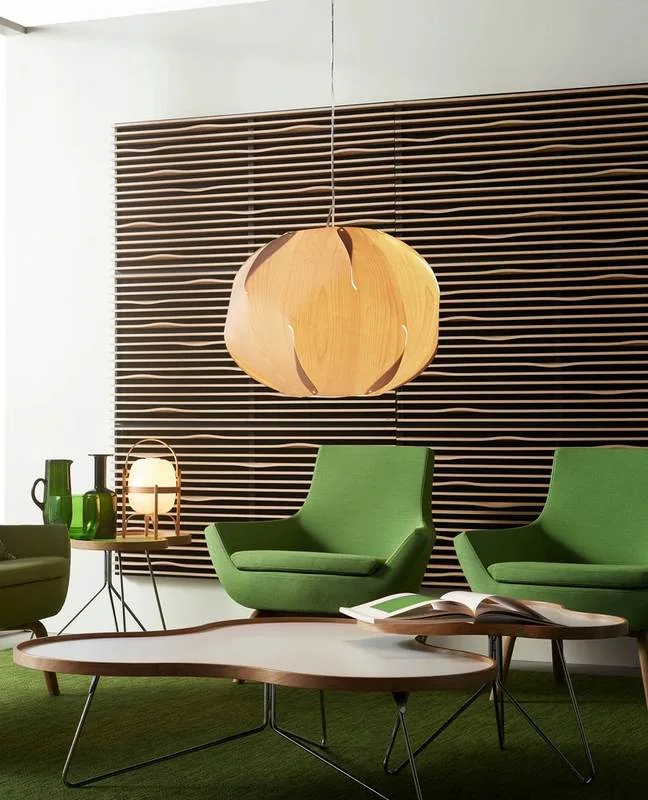 Green lounge chairs under a wood pendant