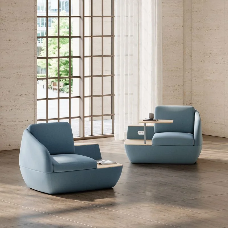 Light blue lounge chairs with tablet arms by tall windows