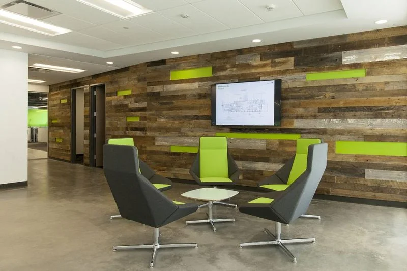 Lime and gray lounge chairs in a reclaimed-wood lobby