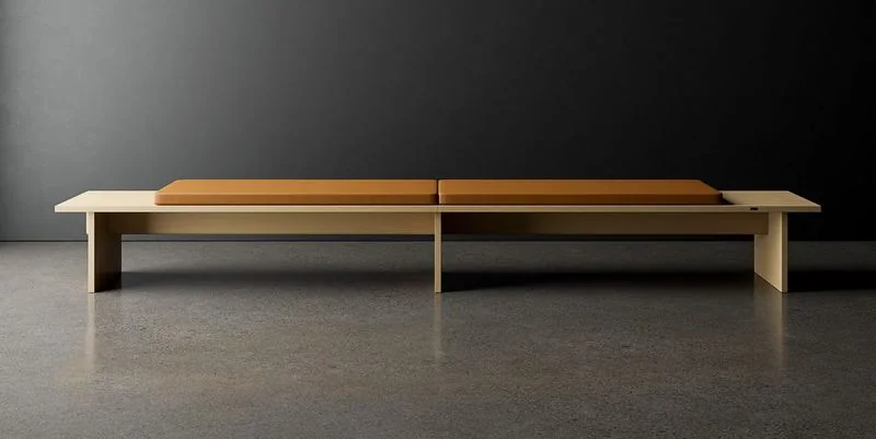 Long wood bench with an ochre cushion