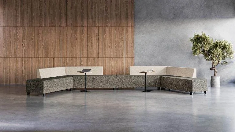 Low modular seating in gray and cream along a wood wall