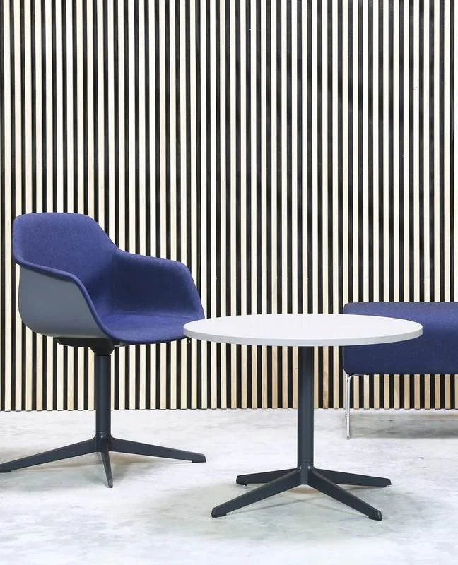 Navy lounge chairs around a white table