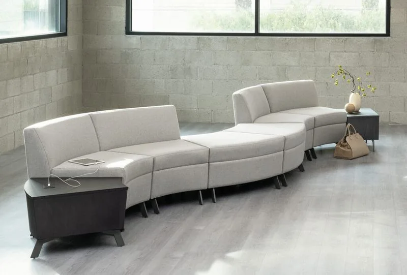 White serpentine modular seating in a gallery space