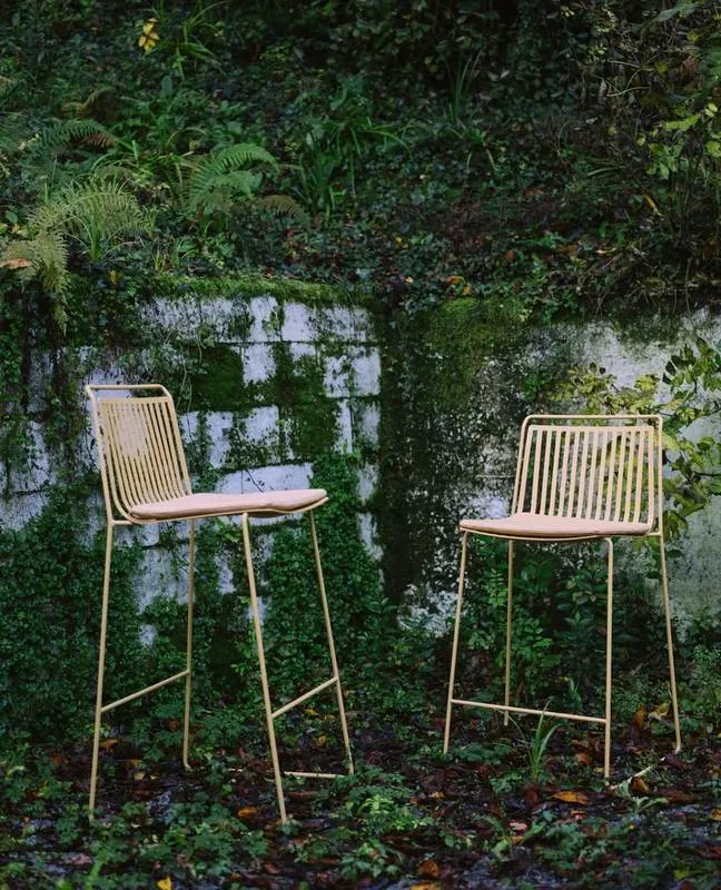 Outdoor Bar Stools Gold wire outdoor bar stools in a garden