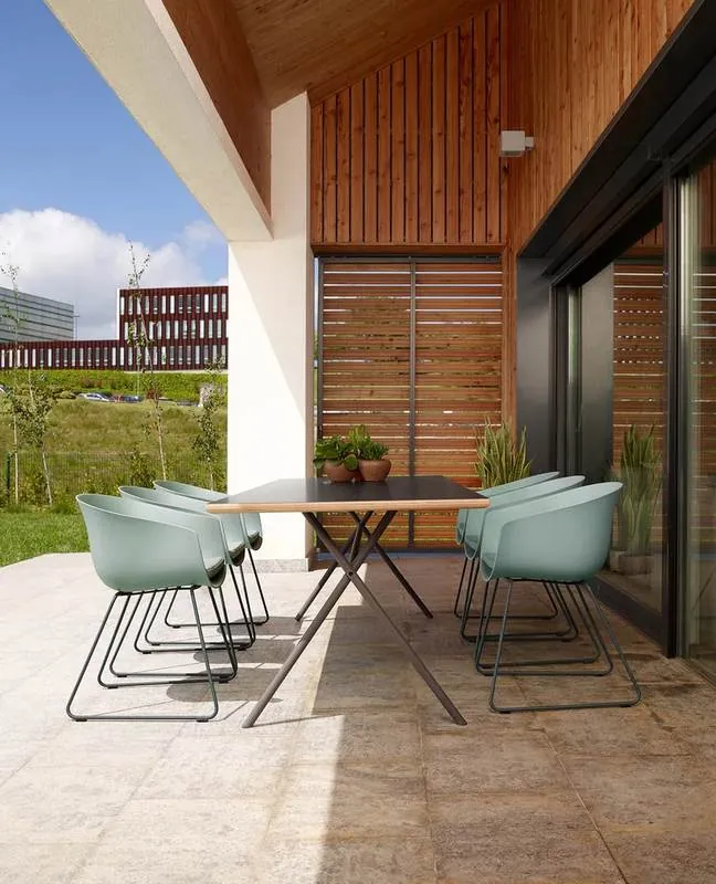 Outdoor Dining Mint shell chairs at an outdoor dining table on a terrace