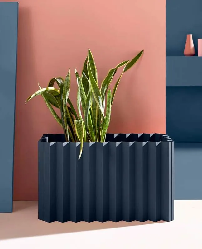 Planter Navy fluted planter against a coral wall