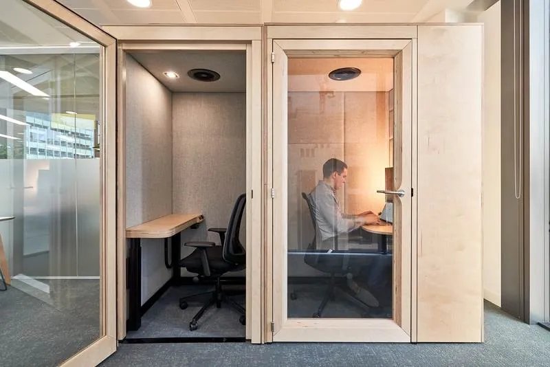 Work Booths Wood-frame work booths with desks and task chairs