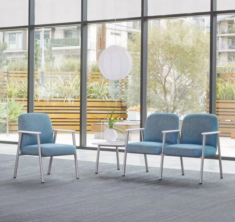 Waiting Area Blue waiting chairs and side tables by a garden window