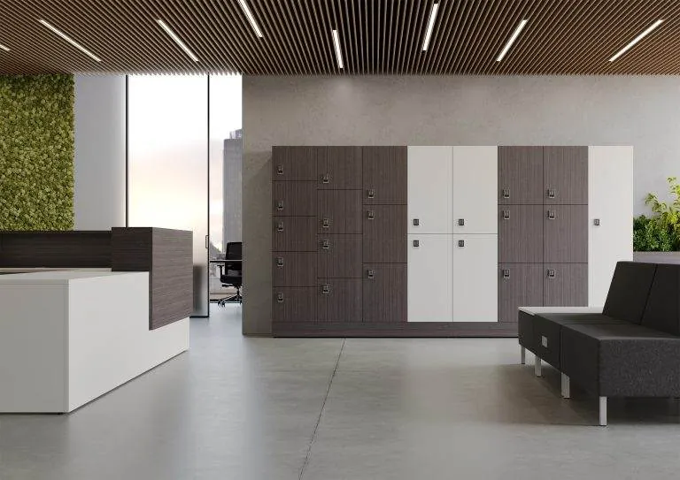 Reception & Lockers White reception desk with storage lockers in a modern lobby