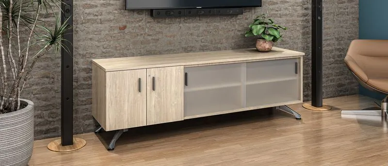 Light wood media credenza under a wall-mounted display