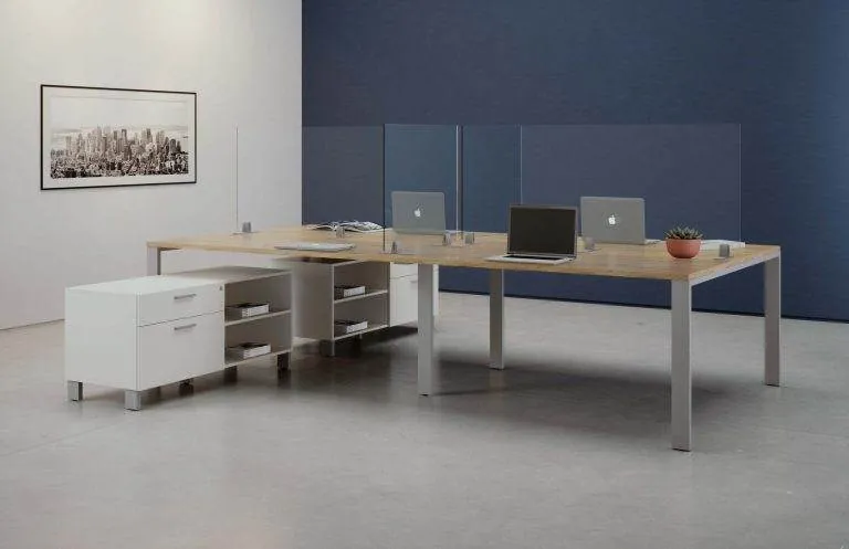 Benching with Storage Benching desks with glass screens and storage against a blue wall