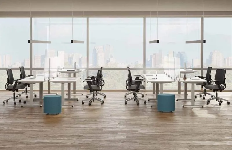 Open Office Benching Open office benching with ottomans by tall windows
