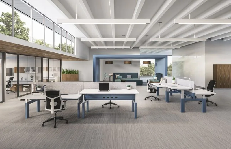 Benching White benching rows with low screens in a bright open office