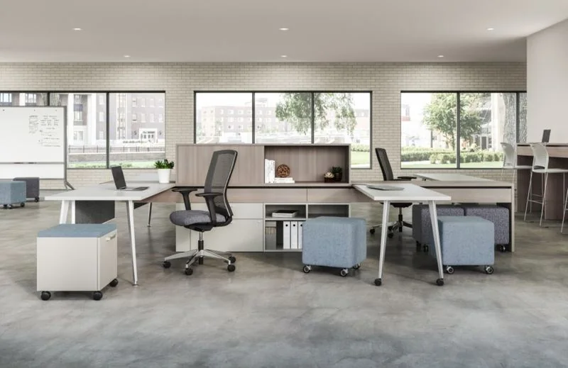 Workstations White L-shaped workstations with mobile pedestals by tall windows
