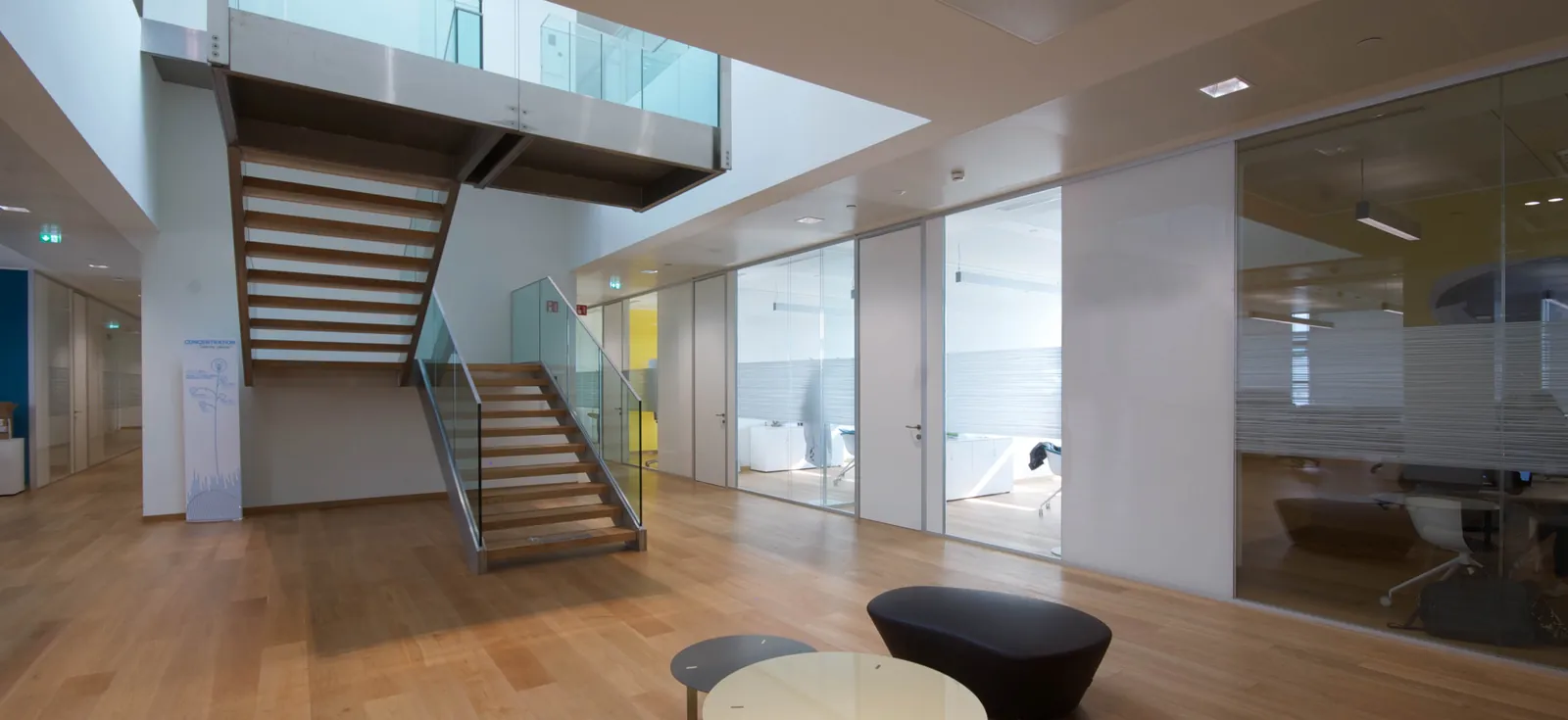 Double Glazed Office Fronts Double glazed glass office fronts along a corridor beside an open staircase