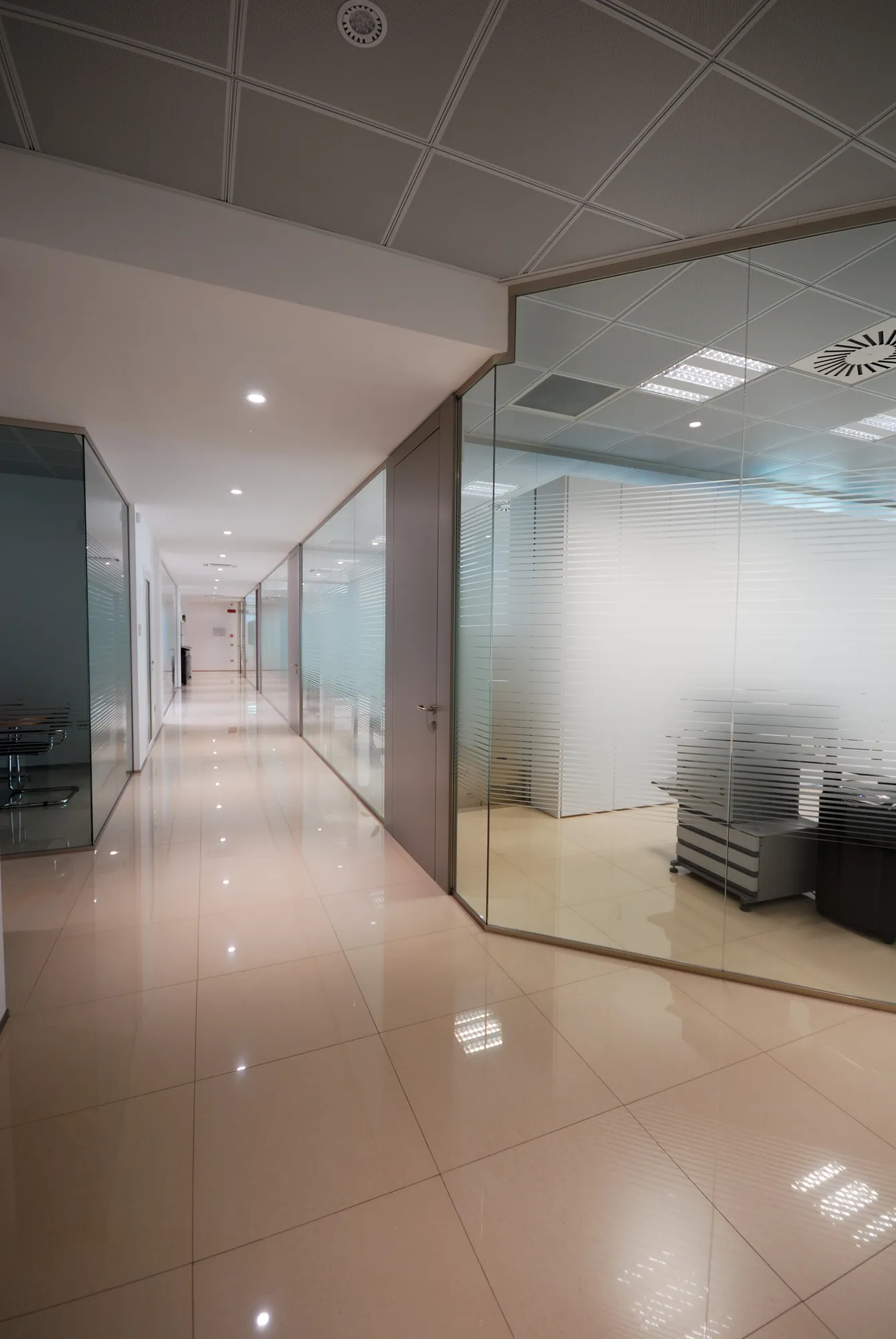 Glass Office Corridor Mono glass offices along a polished-floor corridor