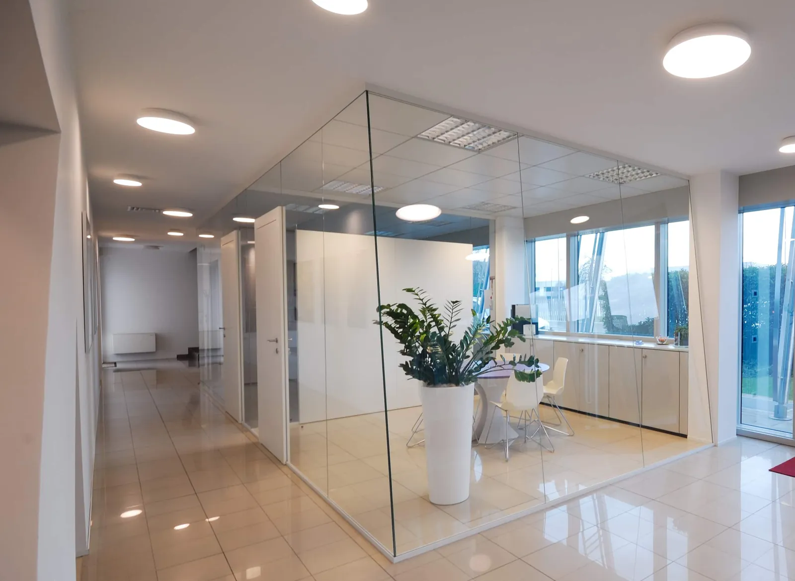 Glass Meeting Room Glass meeting room with solid storage wall behind