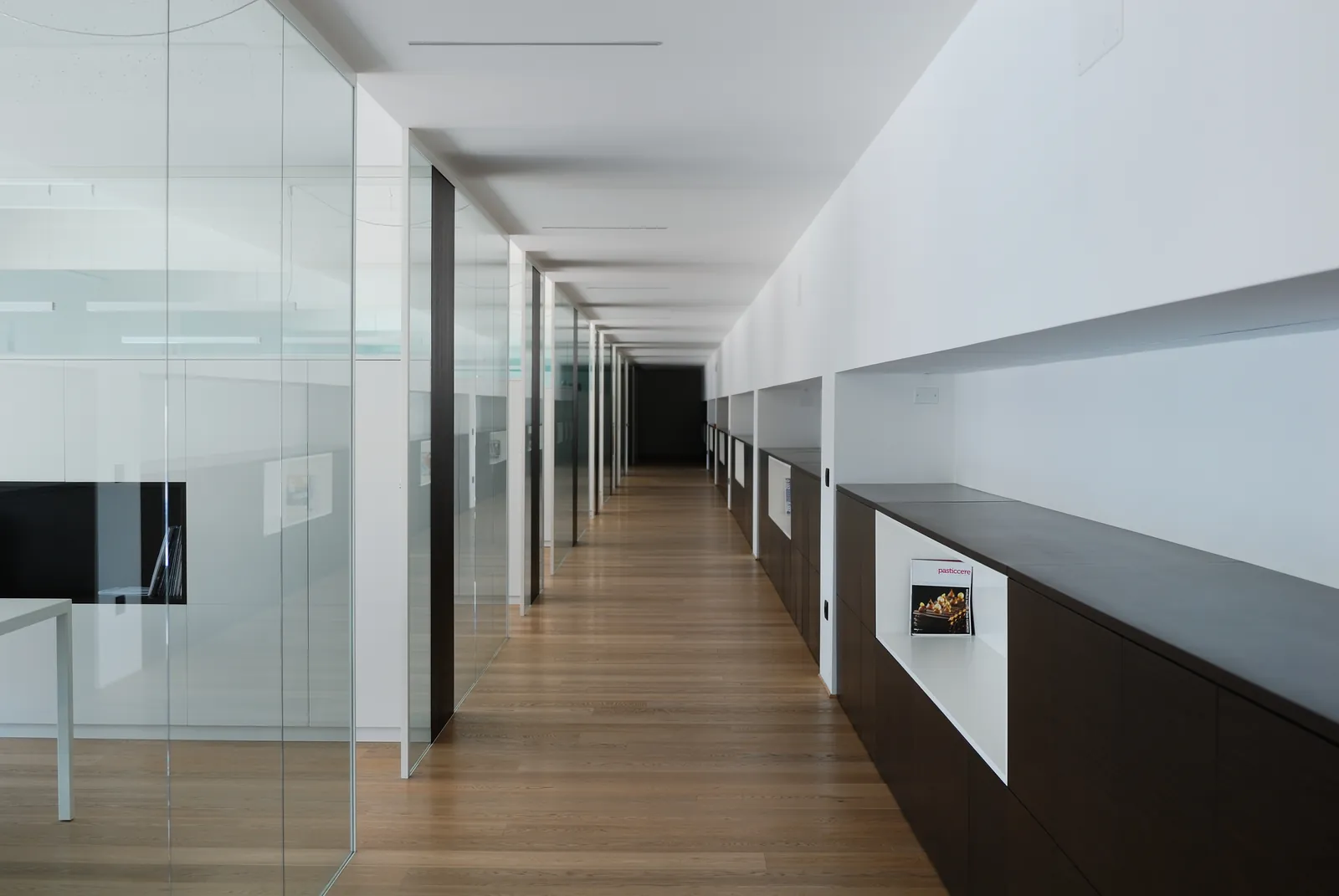 Glass and Solid Corridor Long corridor of glass partitions with white solid panels