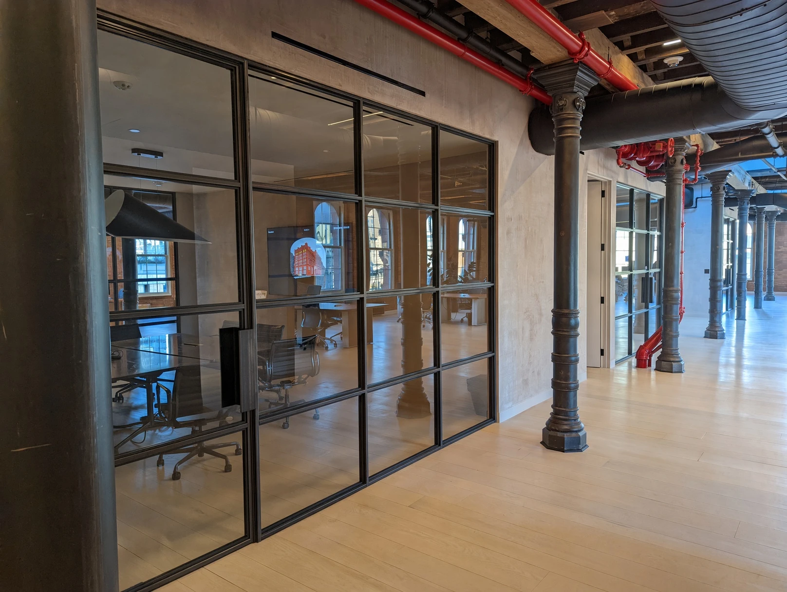 Landmark loft conference room — Metal & Glass · Mill-finish steel glass fronts